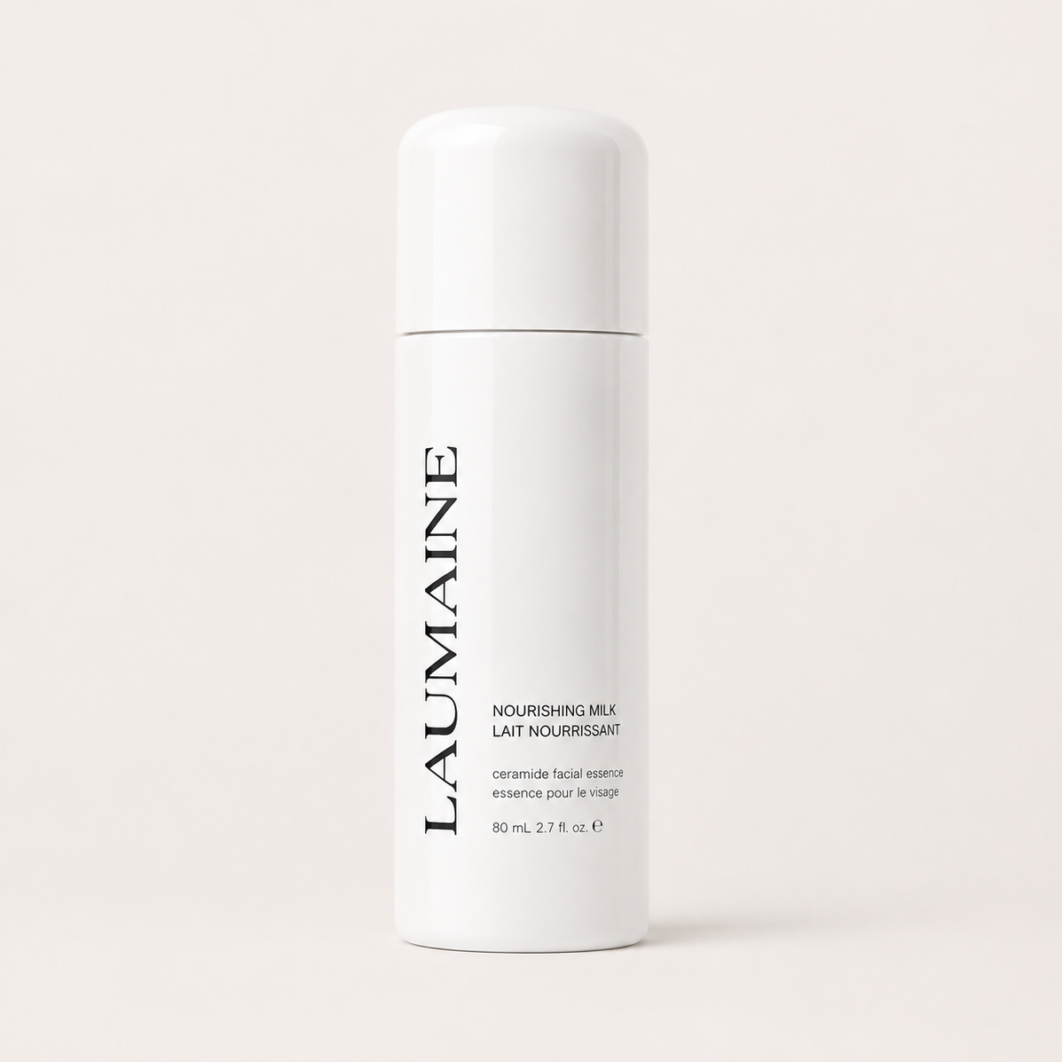 A white cylindrical bottle of LAUMAINE Nourishing Milk essence, featuring black vertical branding text, set against a solid off-white background.
